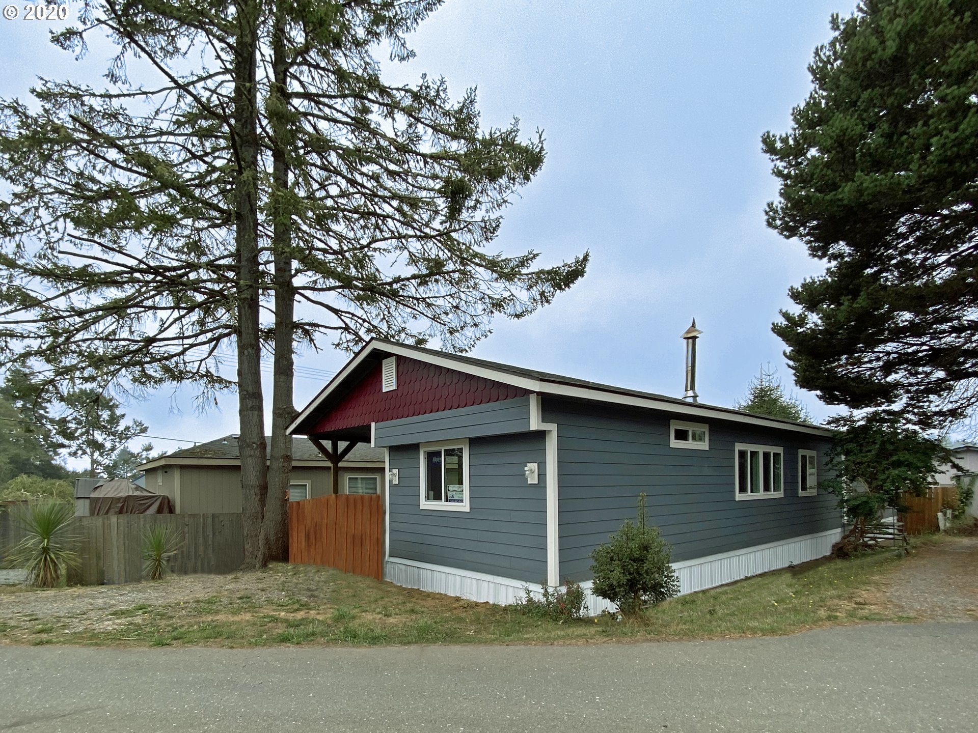 96465 Coverdell Road Brookings, OR 97415 - Photo 1 of 17 a front view of a house with a yard