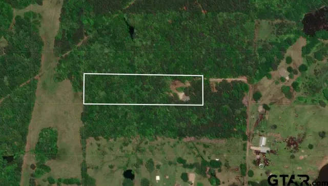 a view of house with backyard