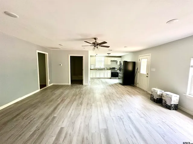 a view of empty room with wooden floor
