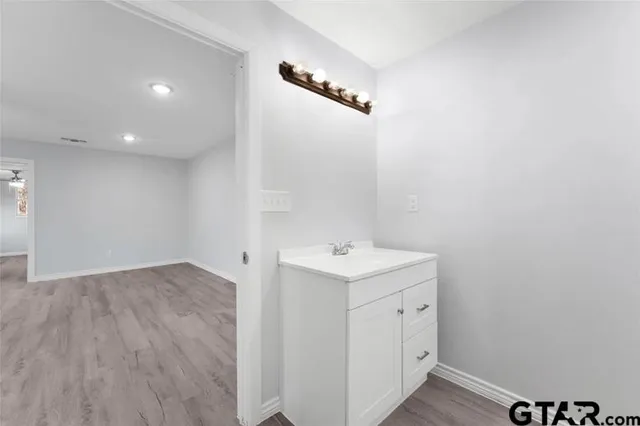 a view of a bathroom with a sink and a mirror