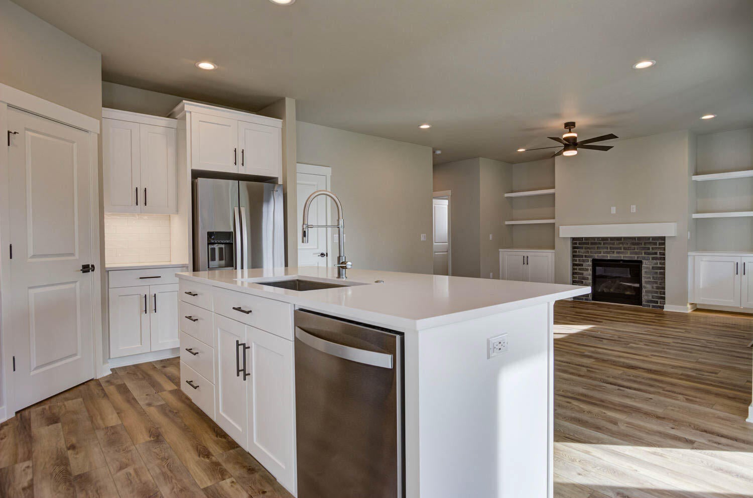 4652 Southwest 36th Street Redmond, OR 97756 - Photo 12 of 36 Greatroom with gas fireplace. Cabinets and shelves are an upgrade and may not be available. Example photo only. Specs and finishes vary.