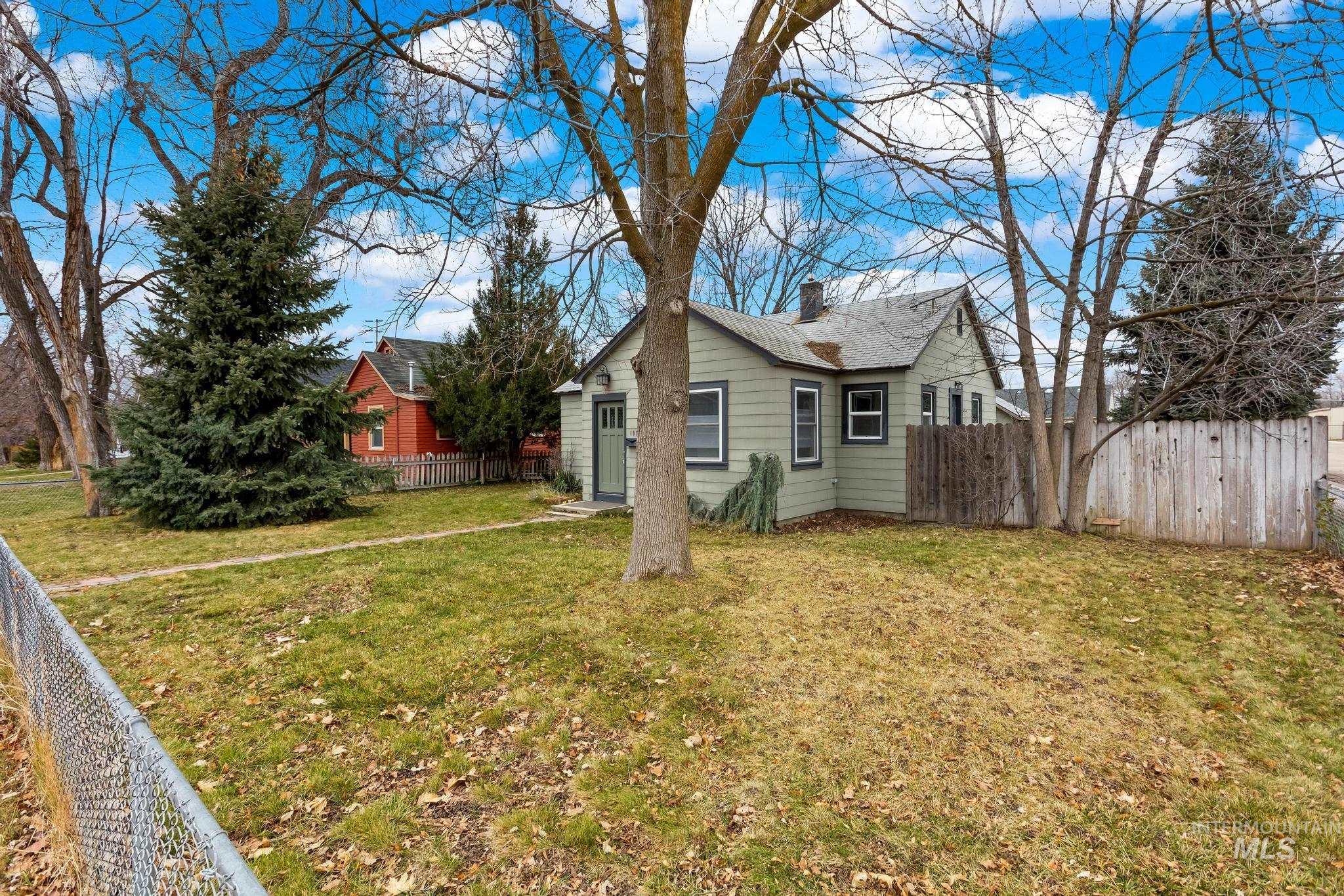 1019 North 30th Street Boise, ID 83702 - Photo 2 of 26 View of side of home with a fenced backyard and a chimney