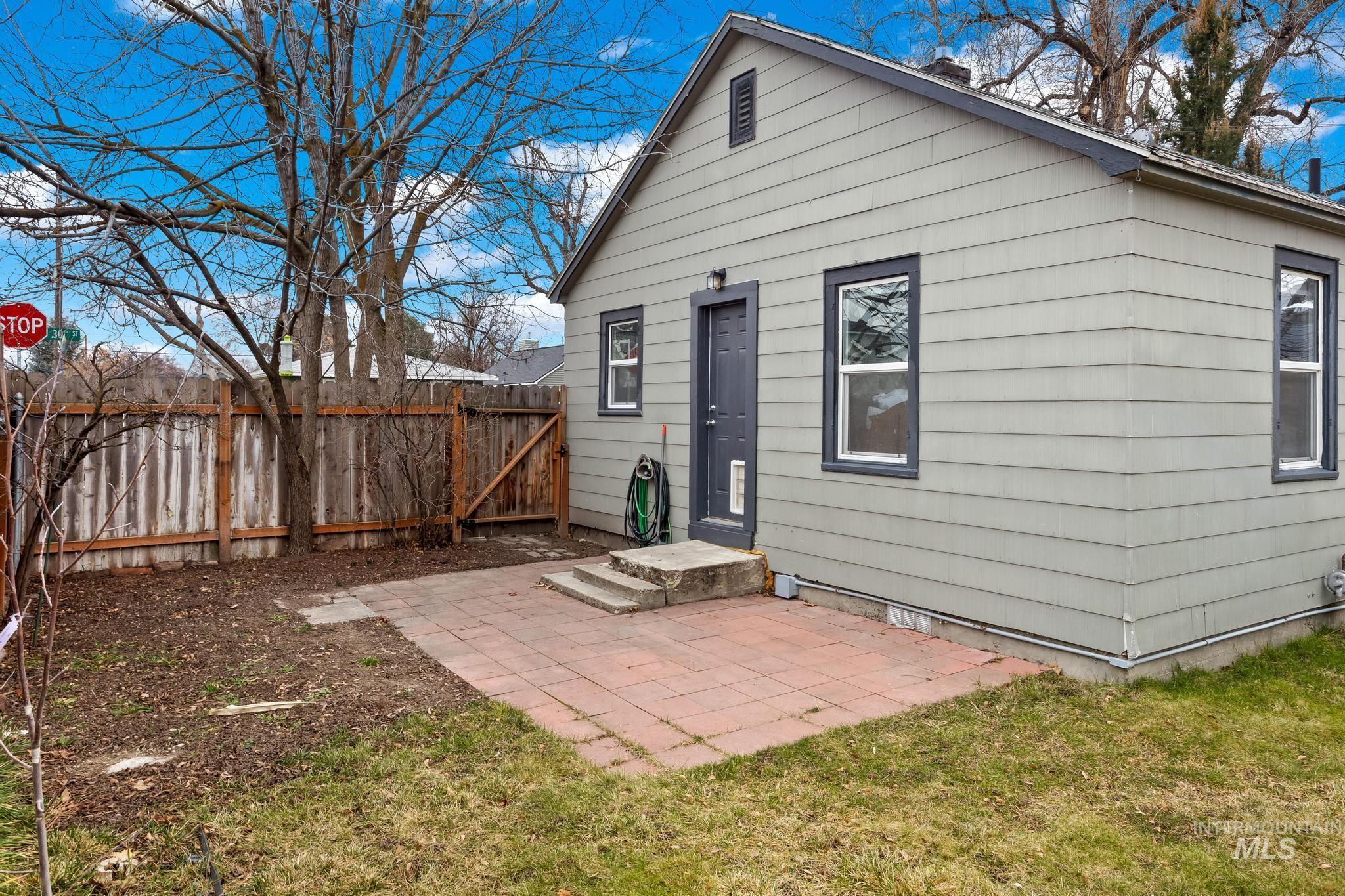 1019 North 30th Street Boise, ID 83702 - Photo 22 of 26 Rear view of house featuring a fenced backyard, a patio area, and a gate