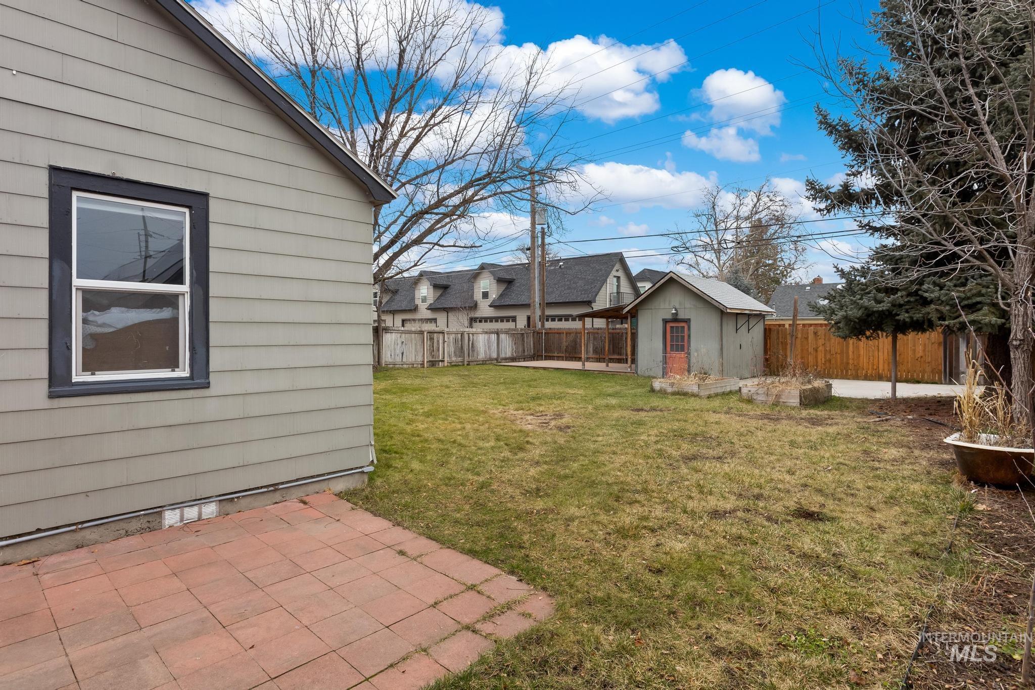 1019 North 30th Street Boise, ID 83702 - Photo 23 of 26 Fenced backyard with an outdoor structure and a patio