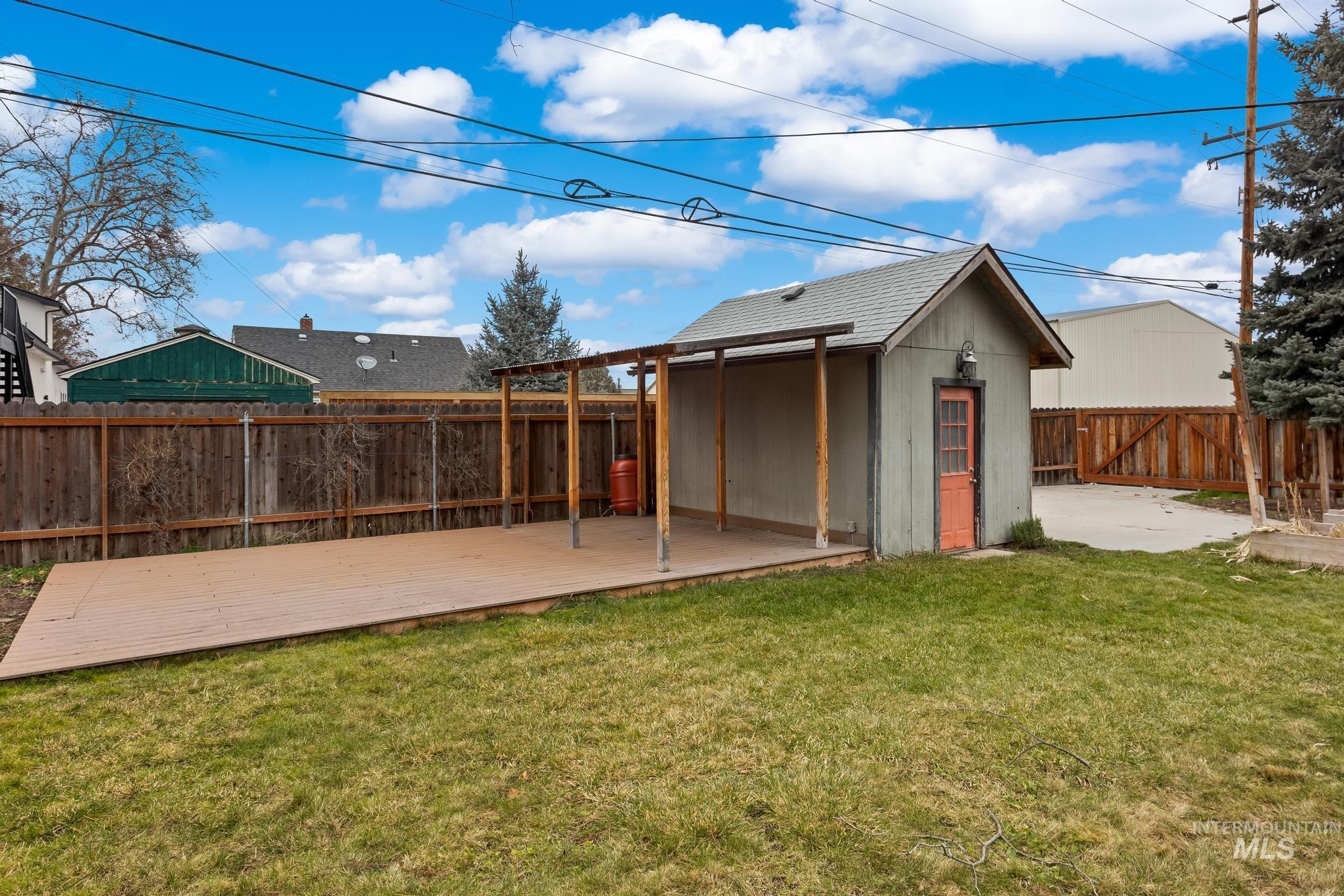 1019 North 30th Street Boise, ID 83702 - Photo 25 of 26 Fenced backyard with an outdoor structure and a wooden deck