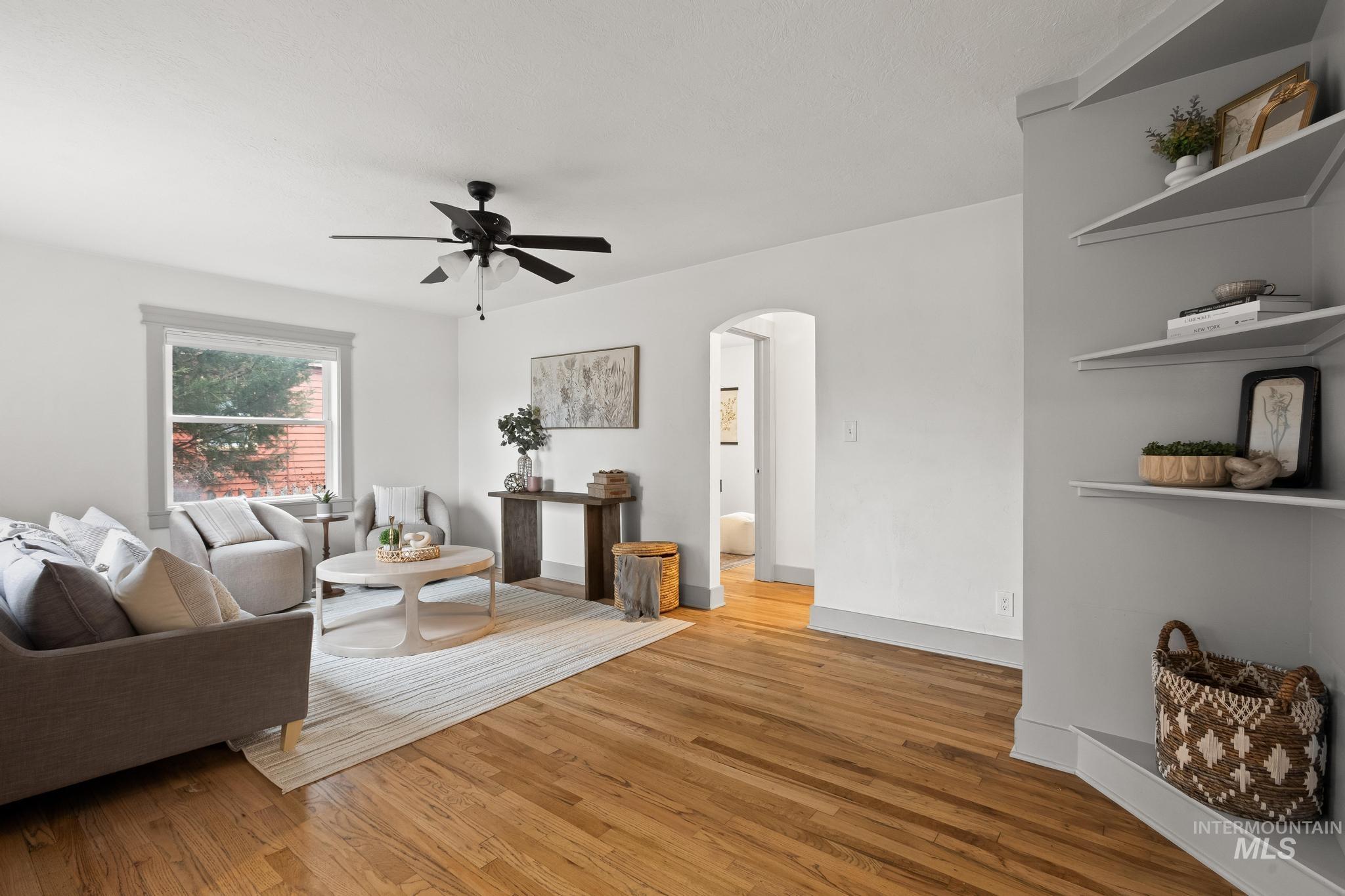 1019 North 30th Street Boise, ID 83702 - Photo 4 of 26 Living area with arched walkways, light wood-style floors, and ceiling fan