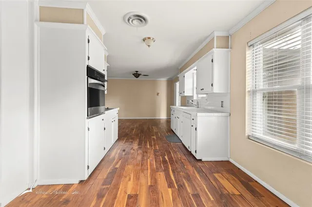 a spacious bathroom with double vanity and a mirror
