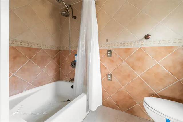 a bathroom with a bathtub and shower