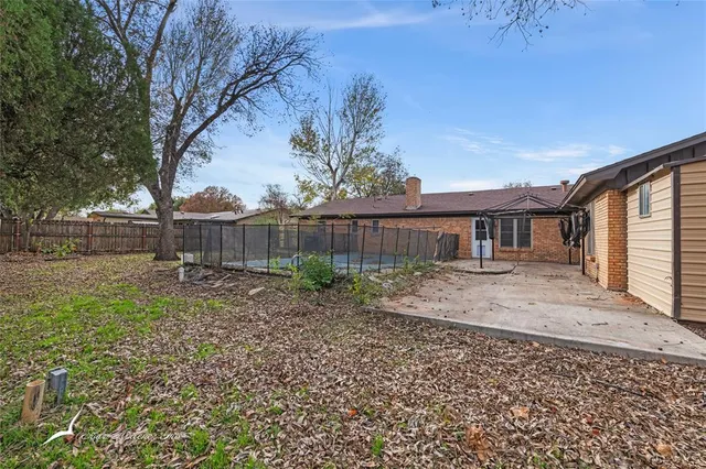 a view of a house with a tree in the yard