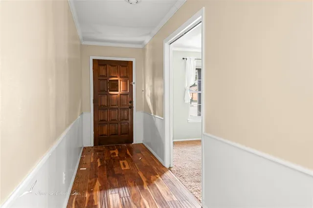 a view of a room with wooden floor and a balcony