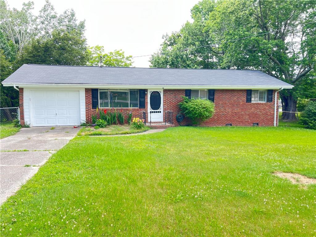 a view of a house with a yard and potted plants