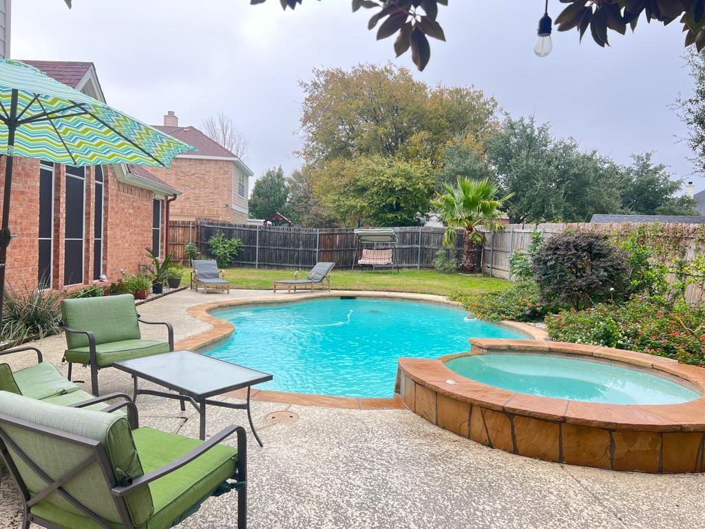 a swimming pool with outdoor seating and yard