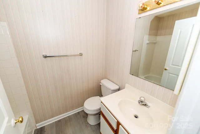 a bathroom with a sink a toilet and shower curtain