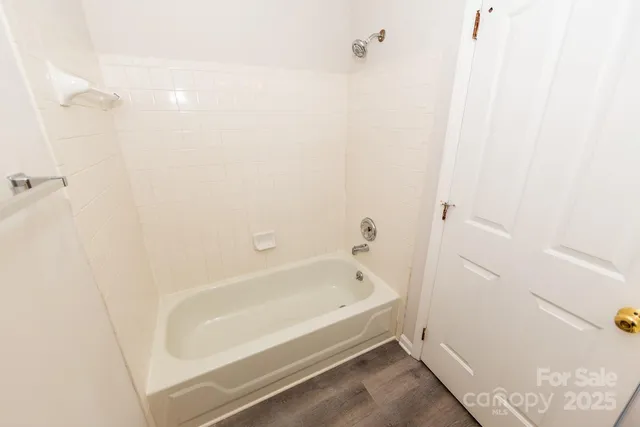 a bathroom with a bathtub and shower