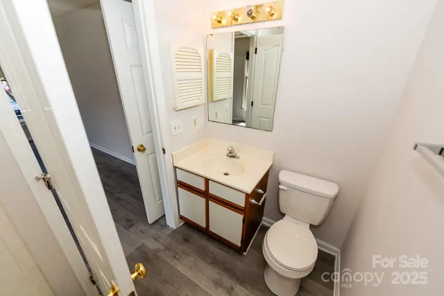 a white toilet sitting next to a bathroom sink