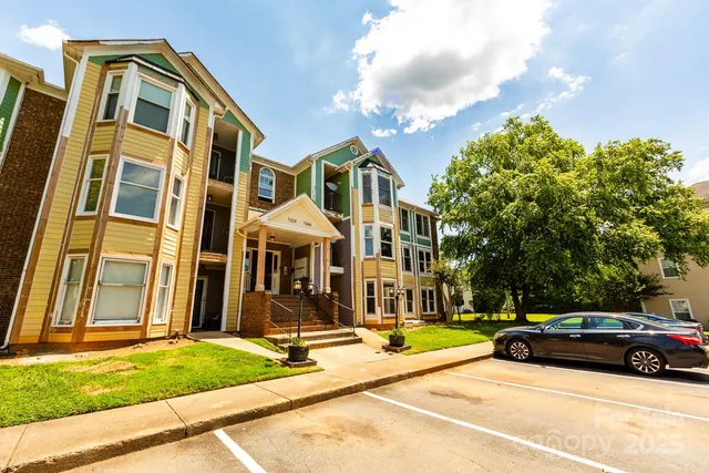 a front view of a residential apartment building with a yard