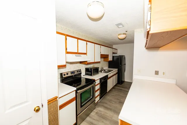 a kitchen with stainless steel appliances granite countertop a stove and a refrigerator
