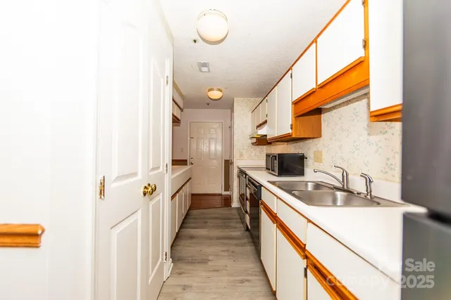 a kitchen with a sink and a refrigerator