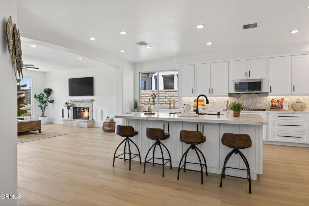 2967 Avenida De Autlan Camarillo, CA 93010 - Photo 15 of 78 a kitchen with a table chairs refrigerator and microwave