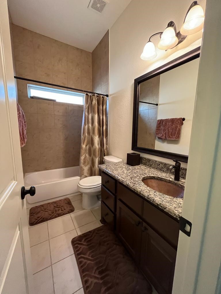 13117 Stoneleigh Terrace Drive Houston, TX 77077 - Photo 12 of 23 a bathroom with a granite countertop sink a toilet and bathtub