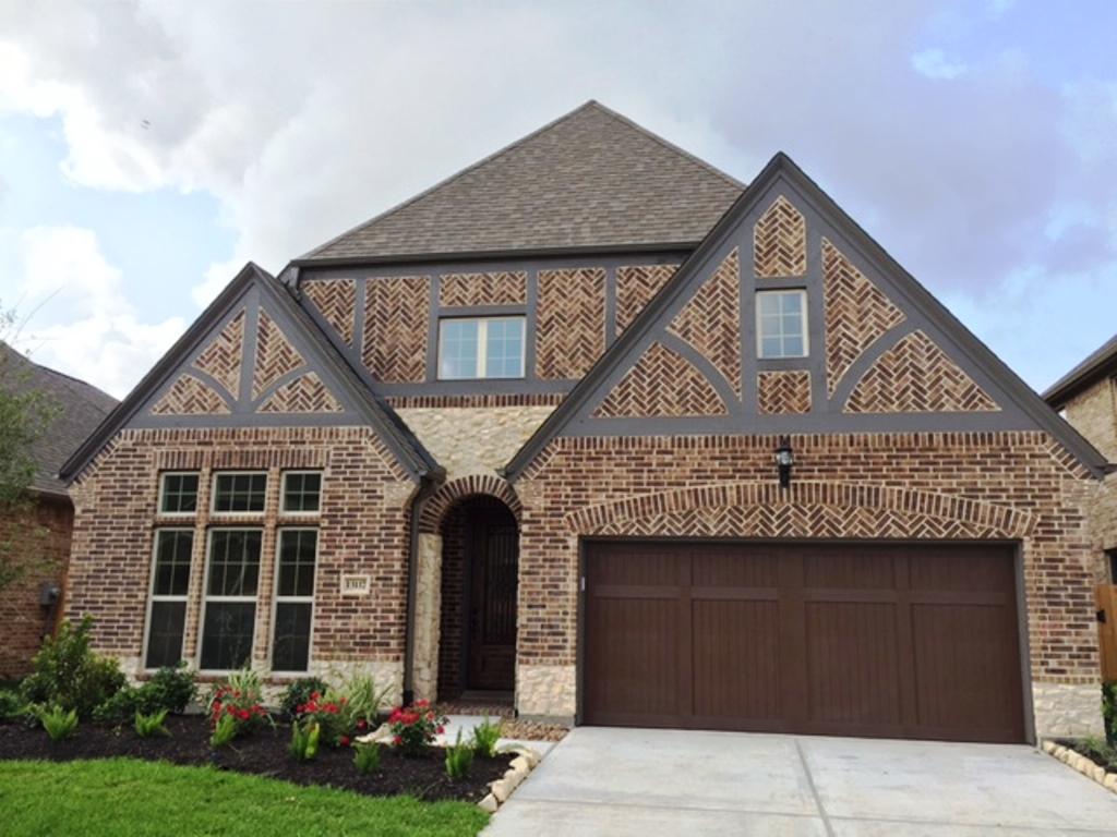 13117 Stoneleigh Terrace Drive Houston, TX 77077 - Photo 2 of 23 a front view of a house with garden