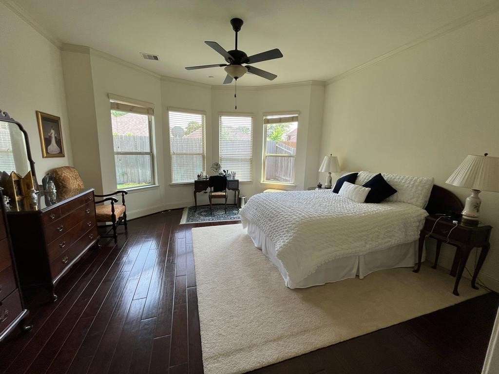 13117 Stoneleigh Terrace Drive Houston, TX 77077 - Photo 4 of 23 a bedroom with a bed and wooden floor