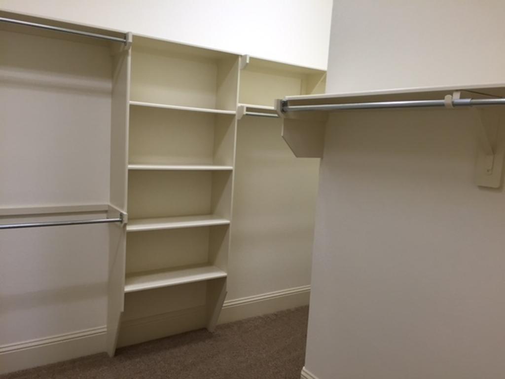 13117 Stoneleigh Terrace Drive Houston, TX 77077 - Photo 6 of 23 a view of walk in closet with empty racks