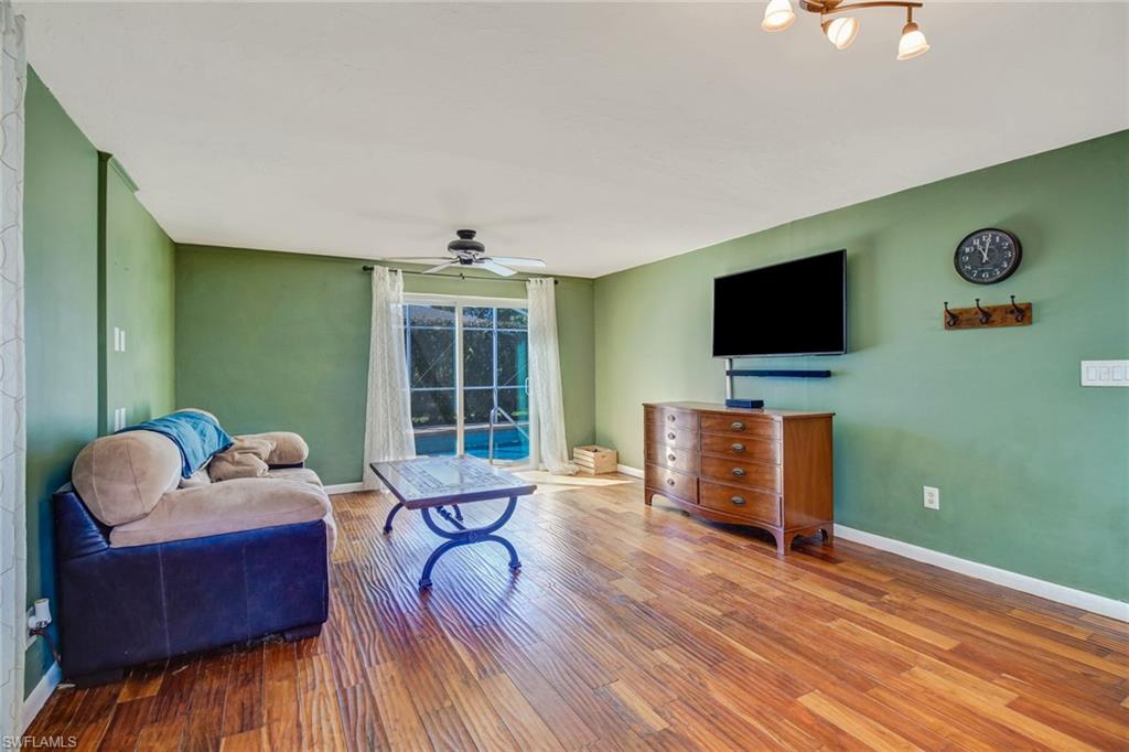 842 Roseate Drive Naples, FL 34104 - Photo 13 of 33 a living room with furniture and a flat screen tv