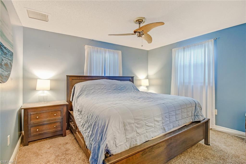 842 Roseate Drive Naples, FL 34104 - Photo 16 of 33 a bedroom with a bed and wooden floor