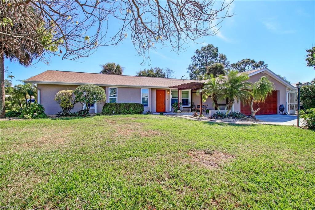 842 Roseate Drive Naples, FL 34104 - Photo 2 of 33 front view of house with a yard