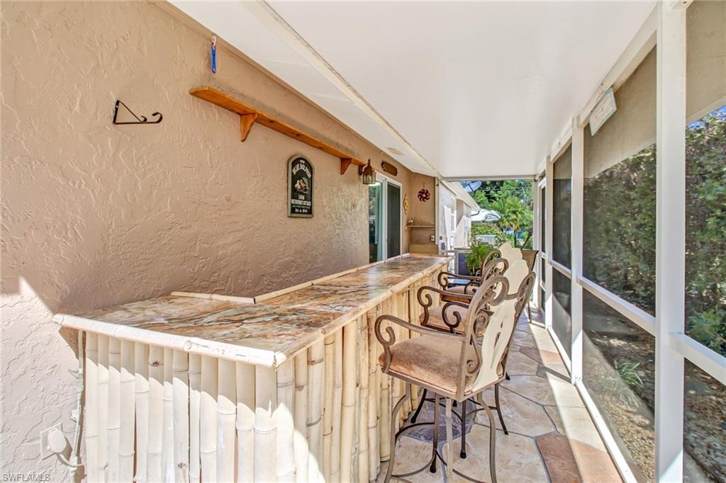 842 Roseate Drive Naples, FL 34104 - Photo 24 of 33 a view of a chairs and table in the balcony