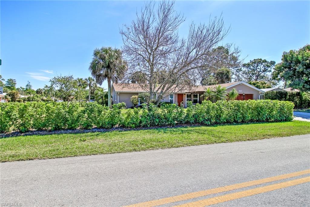 842 Roseate Drive Naples, FL 34104 - Photo 26 of 33 a house that has a tree in front of it