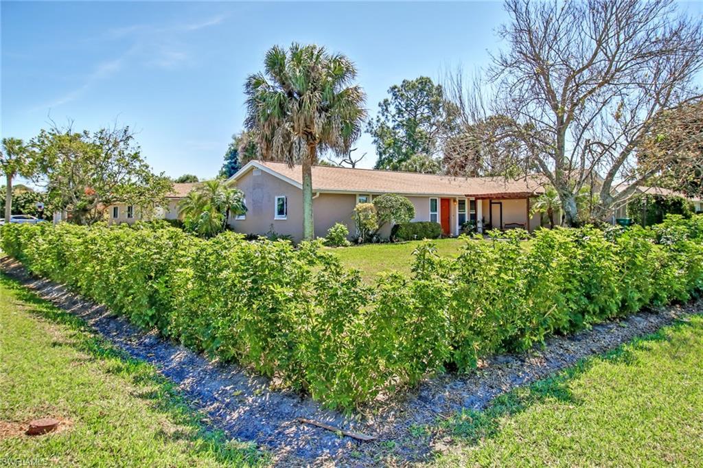 842 Roseate Drive Naples, FL 34104 - Photo 27 of 33 a house view with a garden space