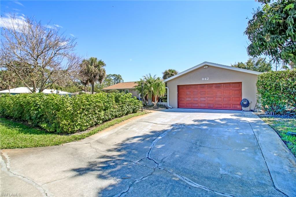 842 Roseate Drive Naples, FL 34104 - Photo 30 of 33 a front view of a house with a yard and garage