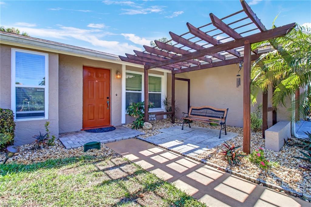 842 Roseate Drive Naples, FL 34104 - Photo 3 of 33 a view of a porch with chairs and a yard