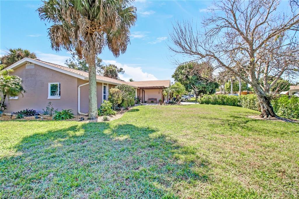 842 Roseate Drive Naples, FL 34104 - Photo 32 of 33 a view of a house with yard and a tree