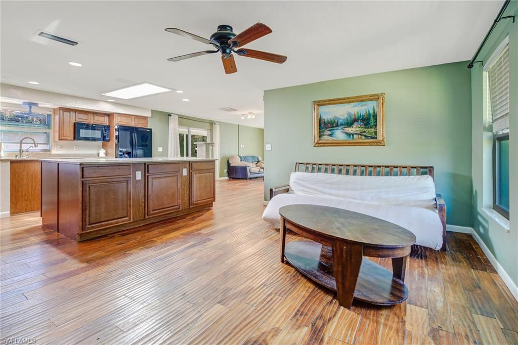 842 Roseate Drive Naples, FL 34104 - Photo 4 of 33 a spacious bedroom with a bed and wooden floor