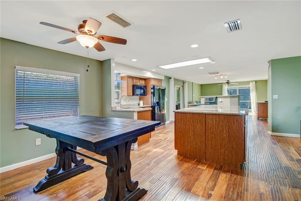842 Roseate Drive Naples, FL 34104 - Photo 7 of 33 a room with wooden floors and lots of furniture