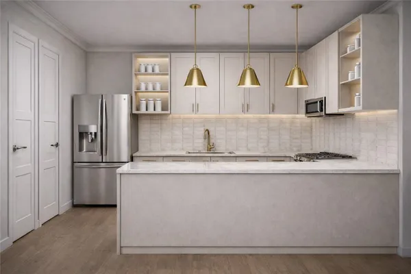 a kitchen with stainless steel appliances granite countertop a refrigerator and a stove