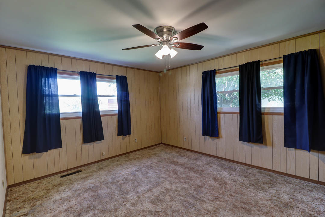 29 Pine Circle Tuscola, IL 61953 - Photo 15 of 27 an empty room with ceiling fan and windows