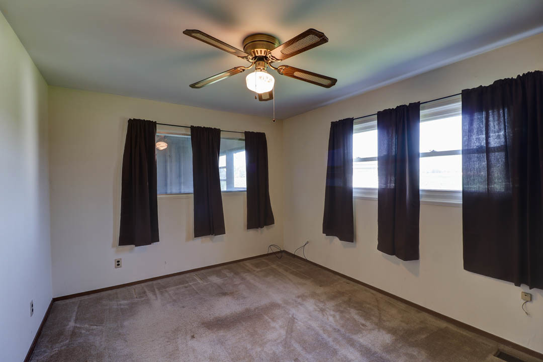 29 Pine Circle Tuscola, IL 61953 - Photo 17 of 27 a view of an empty room with chandelier fan and window