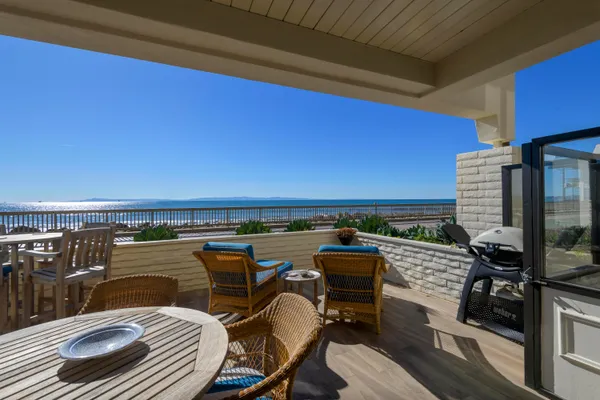 a view of a chairs and table in the balcony