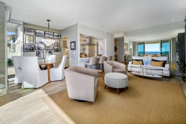 a living room with furniture and a floor to ceiling window