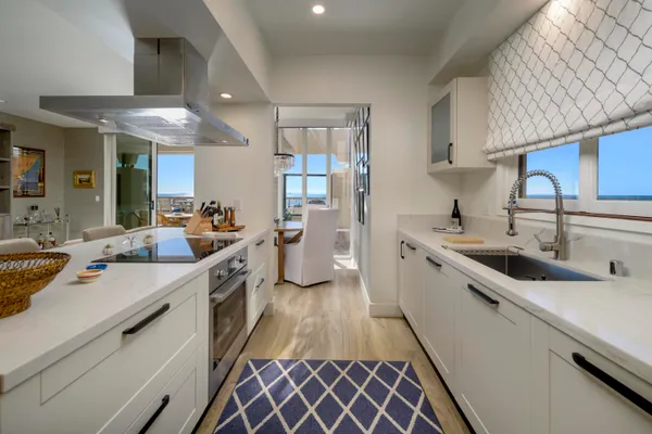 a kitchen with stainless steel appliances a sink stove and cabinets