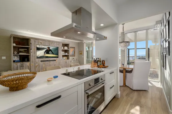 a kitchen that has a sink and a stove with white walls