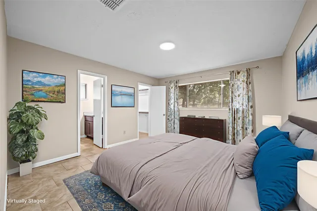 a bedroom with a large bed and a window