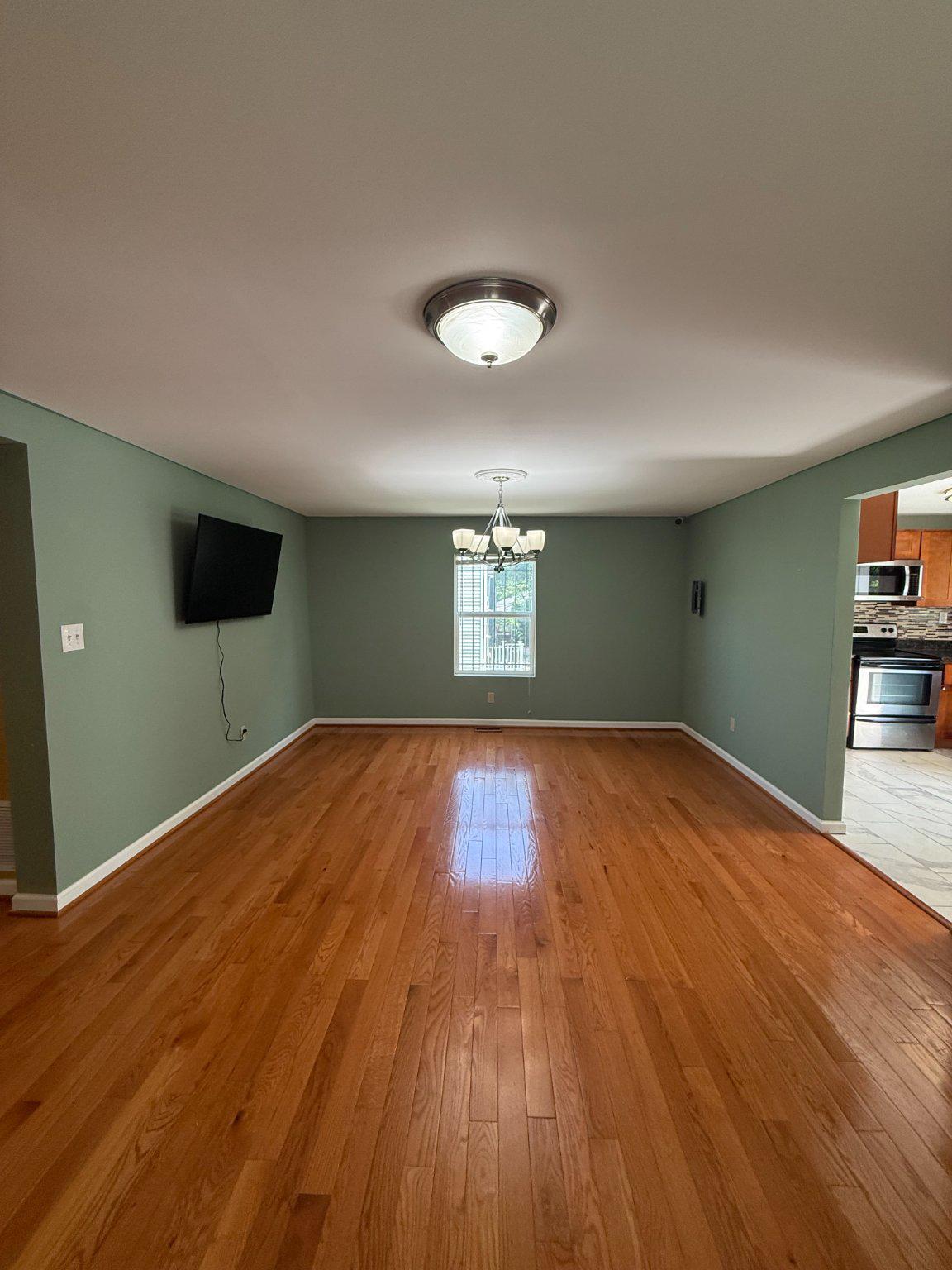 123 Winters Lane Baltimore, MD 21228 - Photo 3 of 28 Spacious living room with warm wooden floors.