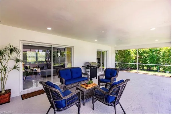 a living room with furniture and a floor to ceiling window