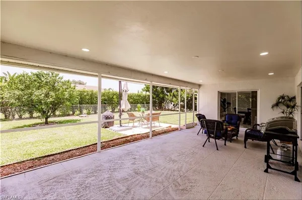 a living room with furniture and floor to ceiling windows