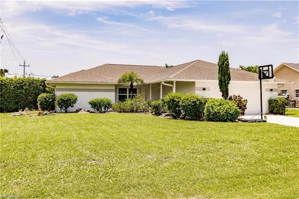 a front view of house with yard and outdoor seating